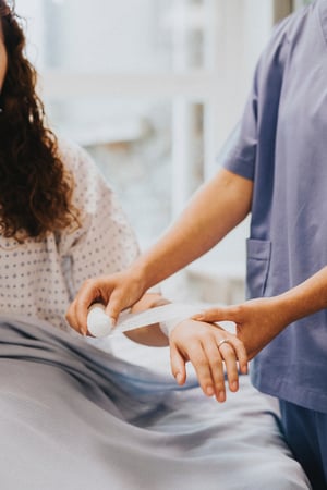 nurse wrapping bandage