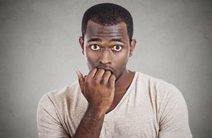 Anxious stressed young man looking at camera