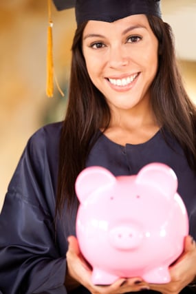 Graduate woman holding a piggybank with her education savings | Hocking College Debuts All-Inclusive Pricing Model