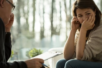 Young depressed woman taking advice from her psychologist | September is National Suicide Prevention Awareness Month